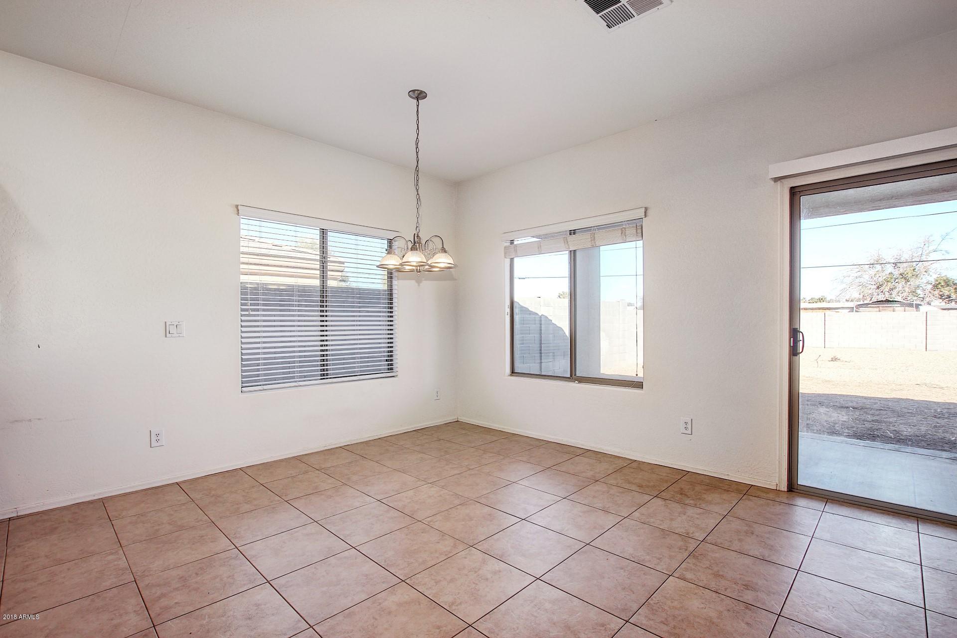 3036 East St John Road Phoenix, AZ 85032 - Photo 10 of 33 a view of an empty room with a window