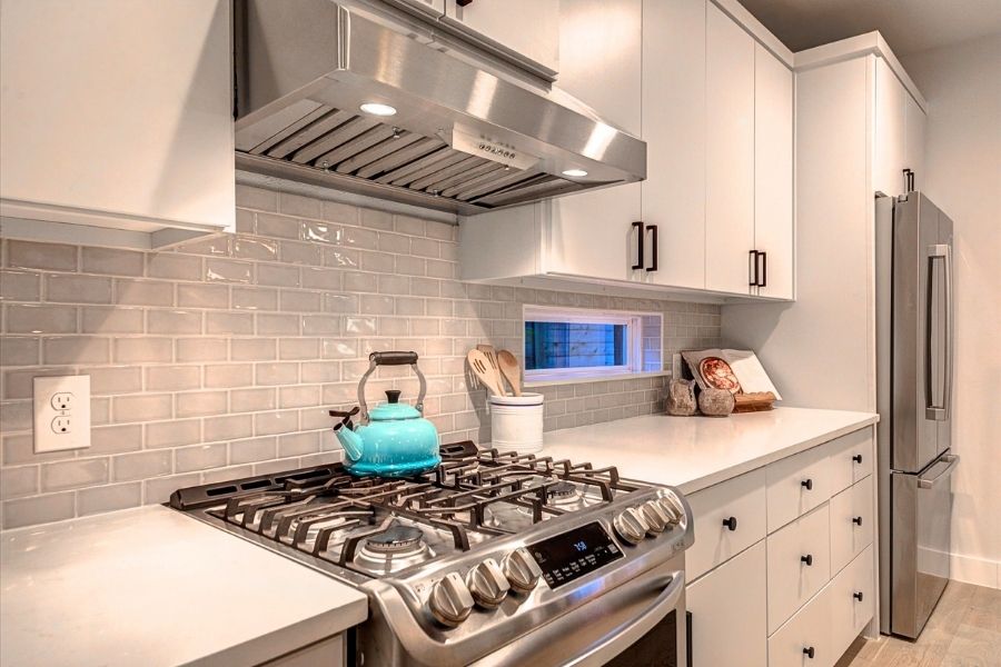 916 East 50th Street, Unit 1 Austin, TX 78751 - Photo 8 of 36 36" stainless steel gas range/oven and vent hood. Windows in the backsplash bring in even more natural light. Fridge conveys!