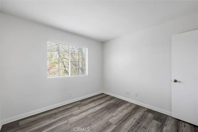 a bathroom with a granite countertop sink a toilet and a mirror