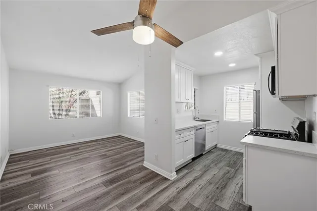 a kitchen with stainless steel appliances a sink stove and cabinets