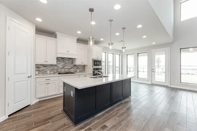 a kitchen with a sink stove and cabinets