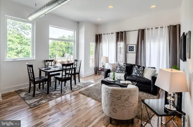 a view of a small space with wooden floor and a window