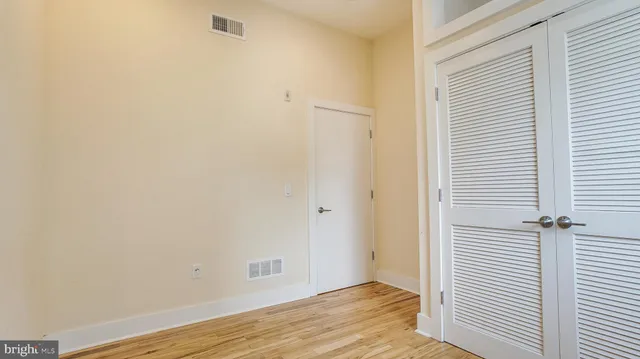 a view of a kitchen with a sink and refrigerator