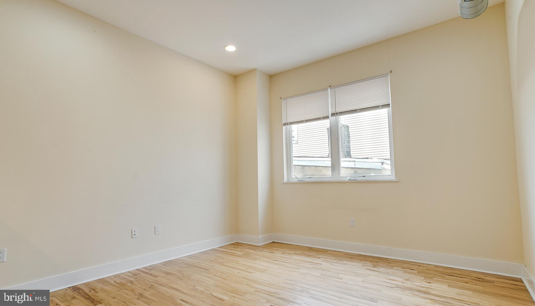 1234 North 30th Street Philadelphia, PA 19121 - Photo 17 of 59 an empty room with wooden floor and windows