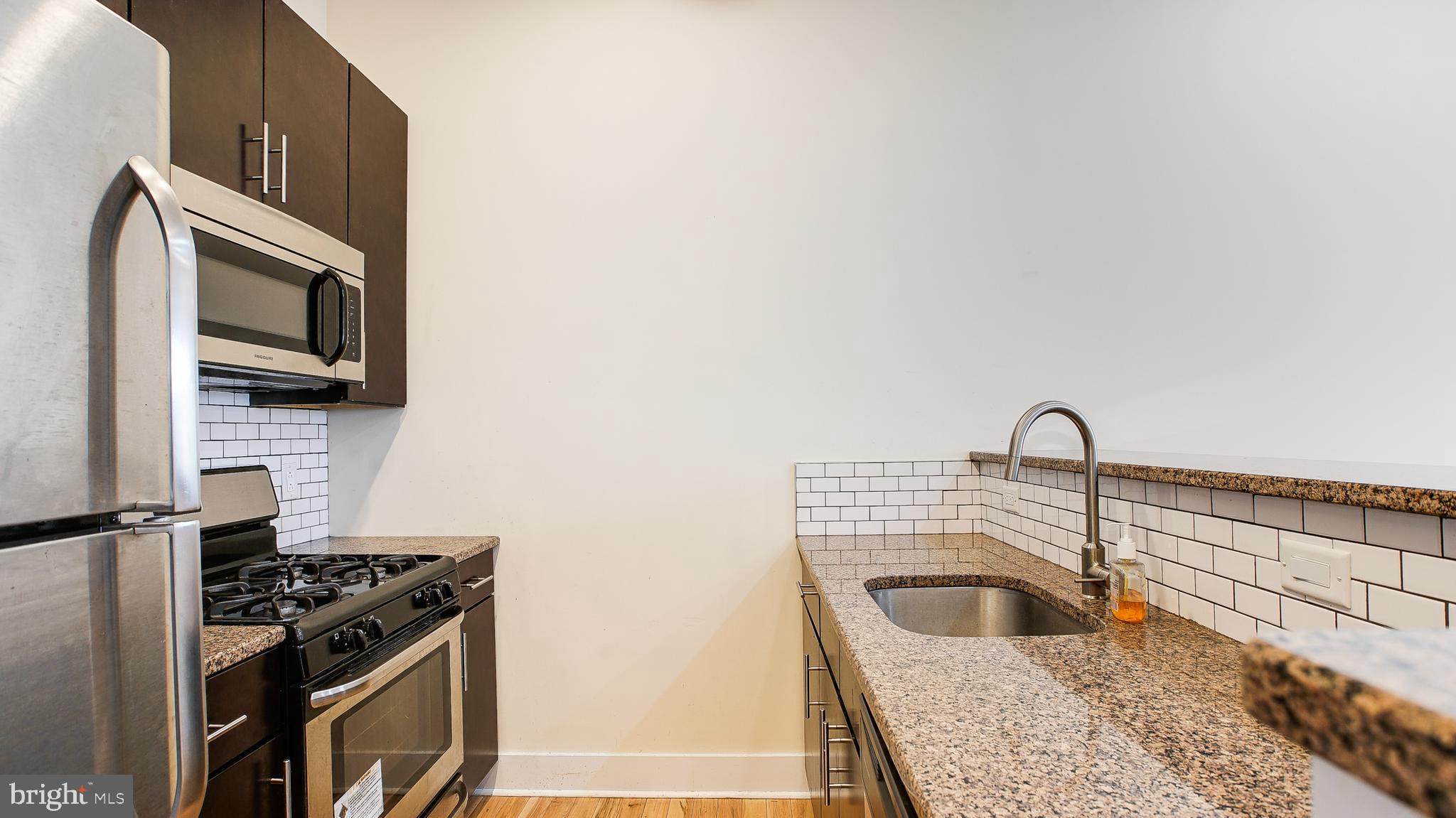 1234 North 30th Street Philadelphia, PA 19121 - Photo 20 of 59 a kitchen with a stove and a sink