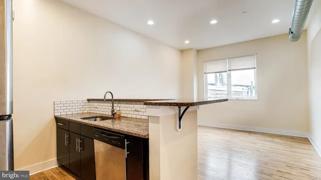 an empty room with wooden floor and a window