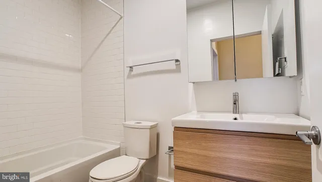 a bedroom with furniture and a wooden floor