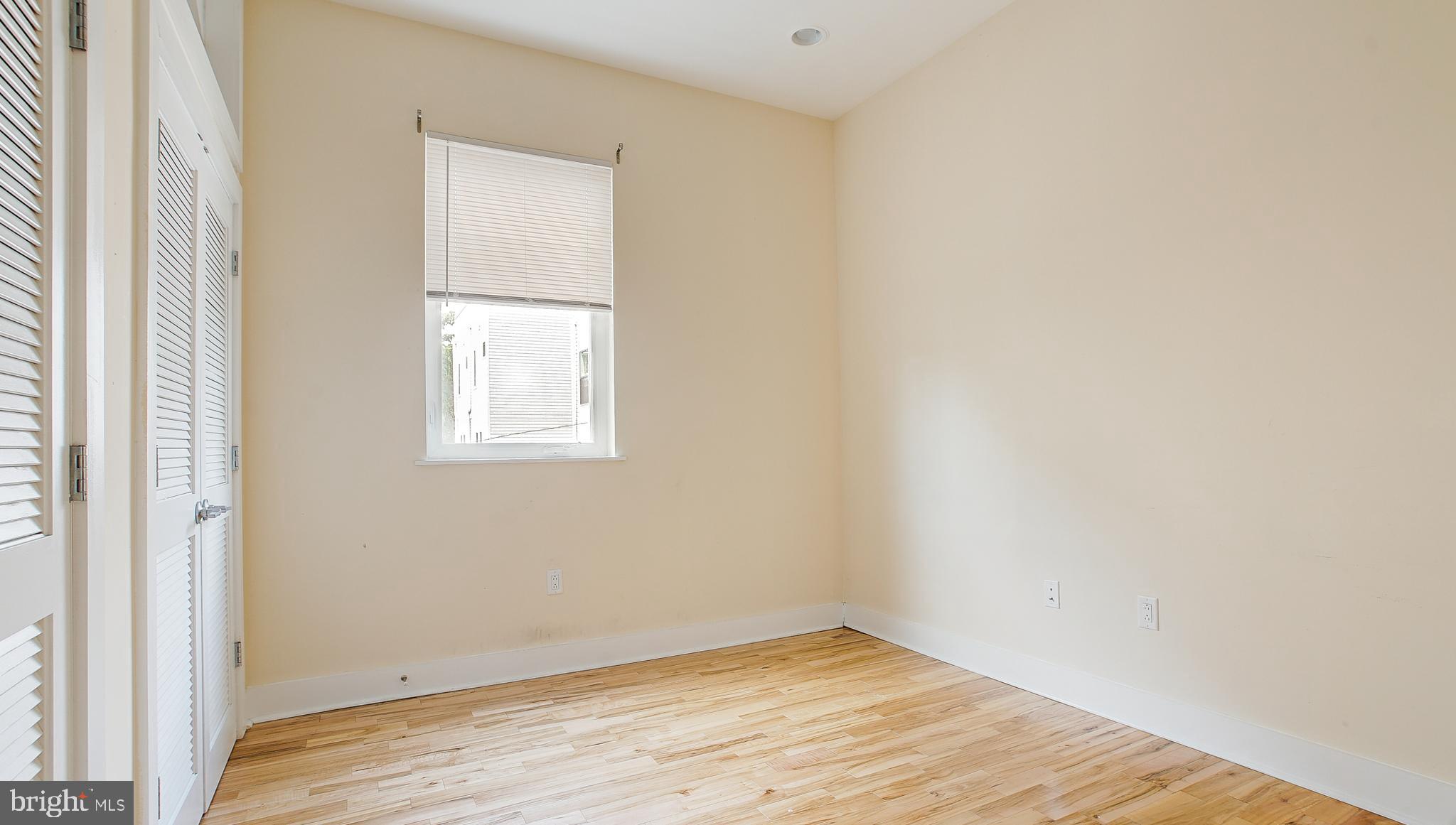 1234 North 30th Street Philadelphia, PA 19121 - Photo 26 of 59 an empty room with wooden floor and a window