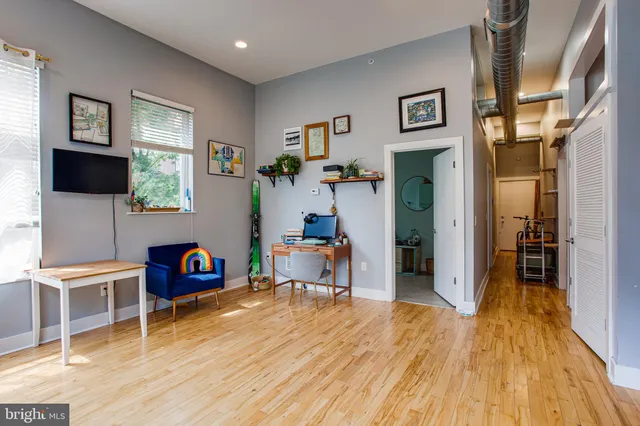 a utility room with lots of clutter and cabinets