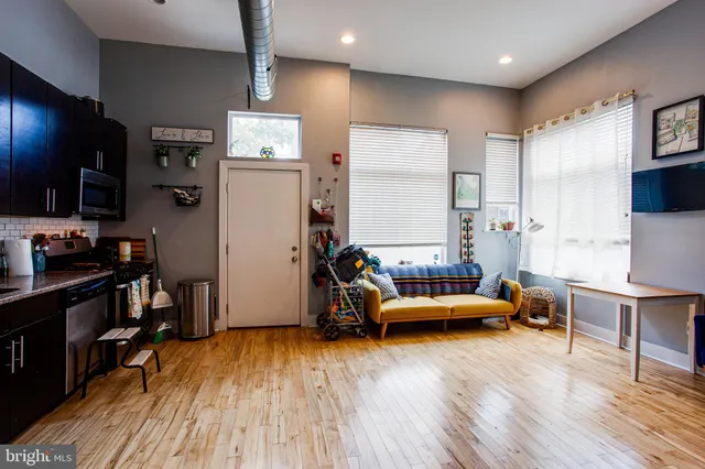 a living room with furniture and a chair