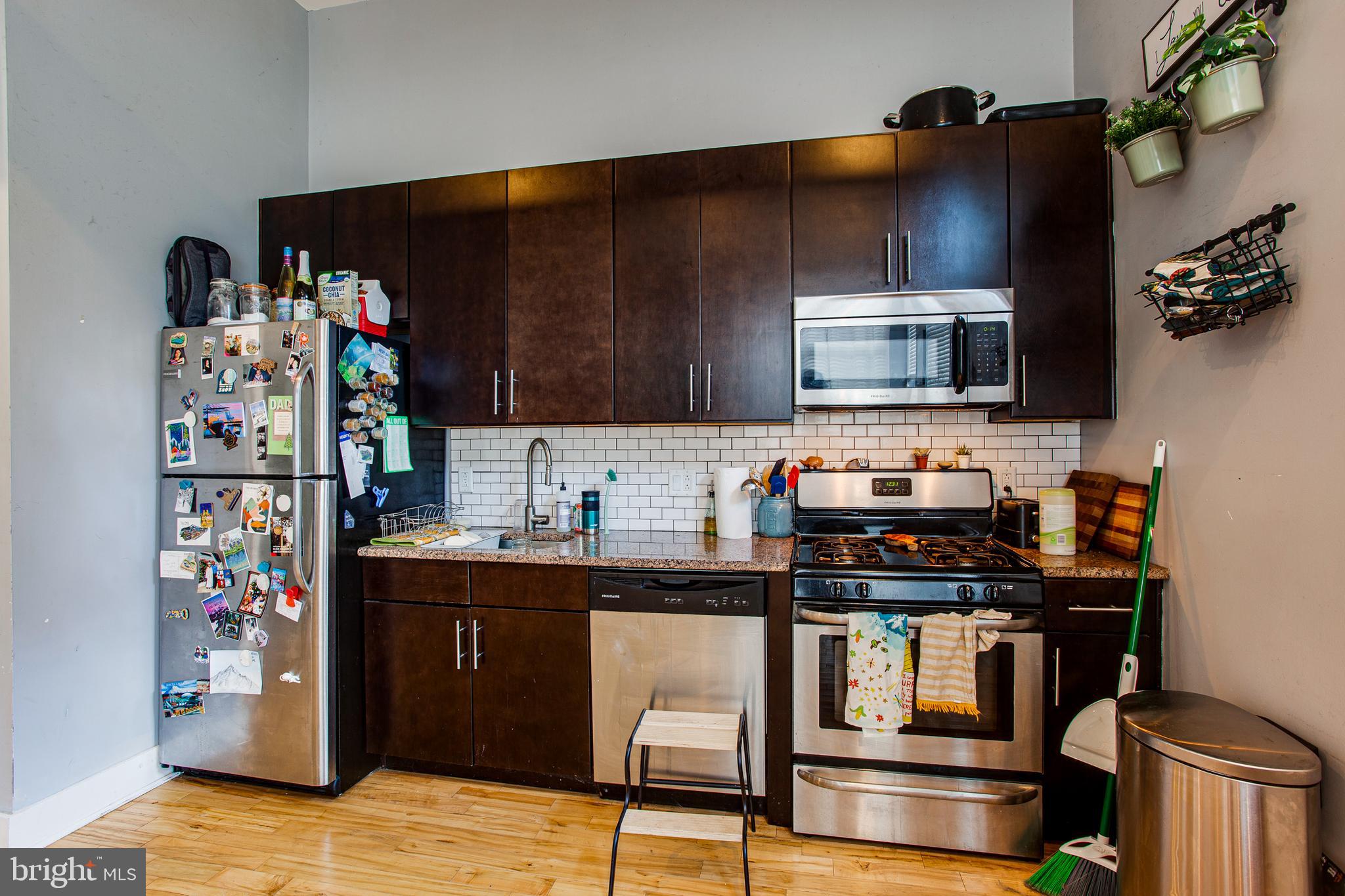 1234 North 30th Street Philadelphia, PA 19121 - Photo 29 of 59 a kitchen with stainless steel appliances a stove refrigerator sink and microwave