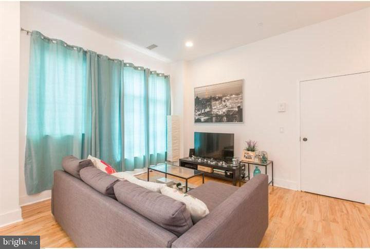 1234 North 30th Street Philadelphia, PA 19121 - Photo 38 of 59 a living room with furniture and a flat screen tv