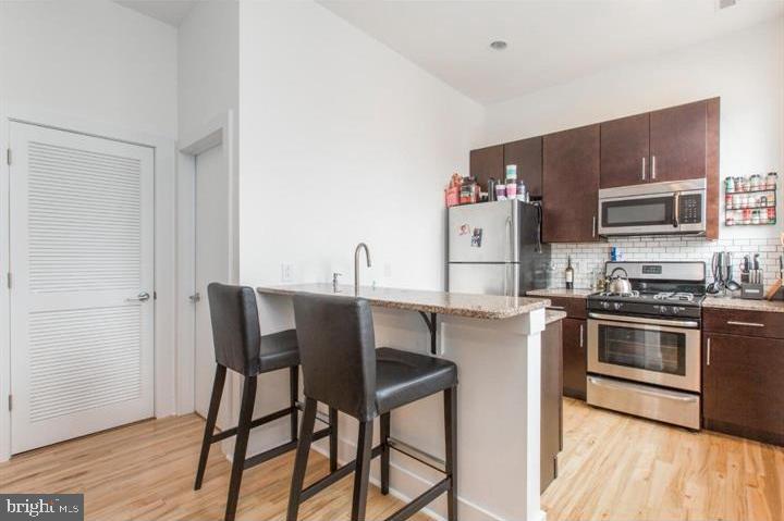 1234 North 30th Street Philadelphia, PA 19121 - Photo 40 of 59 a kitchen with stainless steel appliances granite countertop a stove a sink dishwasher and a refrigerator