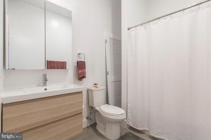1234 North 30th Street Philadelphia, PA 19121 - Photo 43 of 59 a bathroom with a sink a toilet and a mirror