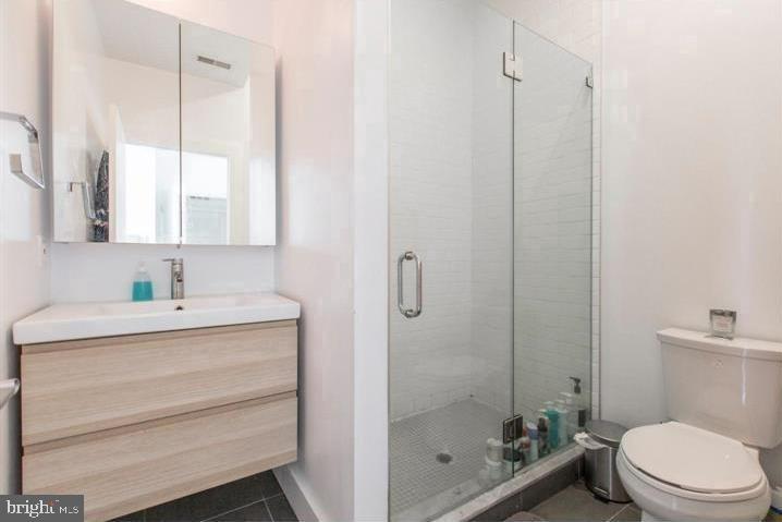 1234 North 30th Street Philadelphia, PA 19121 - Photo 44 of 59 a bathroom with a granite countertop sink a toilet and shower