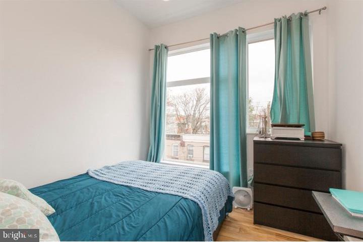 1234 North 30th Street Philadelphia, PA 19121 - Photo 46 of 59 a bedroom with a bed and a large window