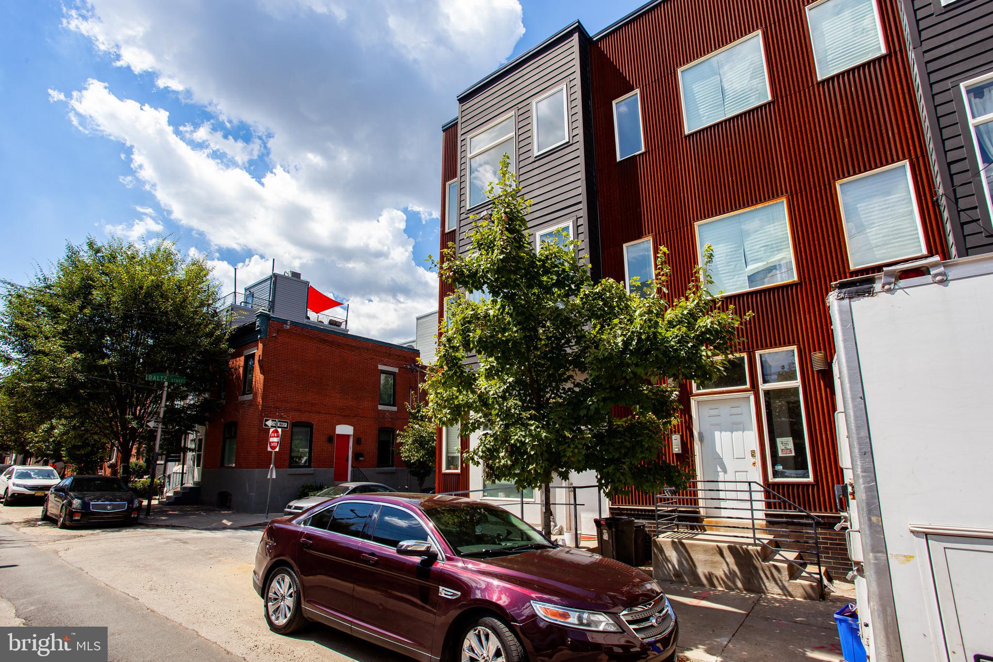 1234 North 30th Street Philadelphia, PA 19121 - Photo 56 of 59 a front view of a residential apartment building with a yard