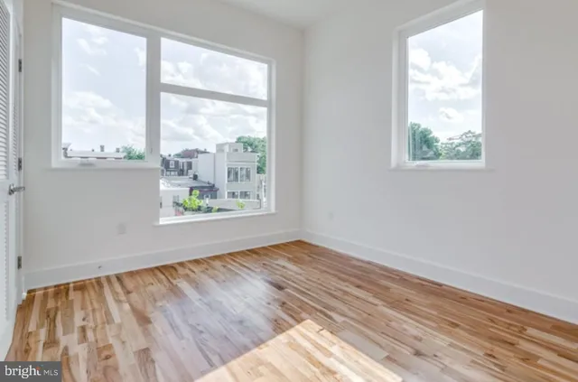 a view of a room with wooden floor and a bathroom