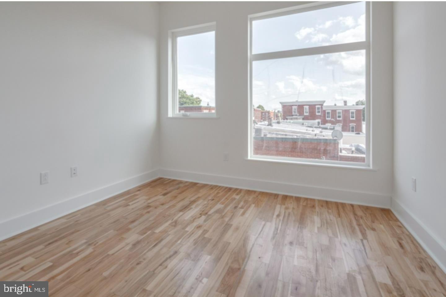 1234 North 30th Street Philadelphia, PA 19121 - Photo 9 of 59 a view of an empty room with wooden floor and a window