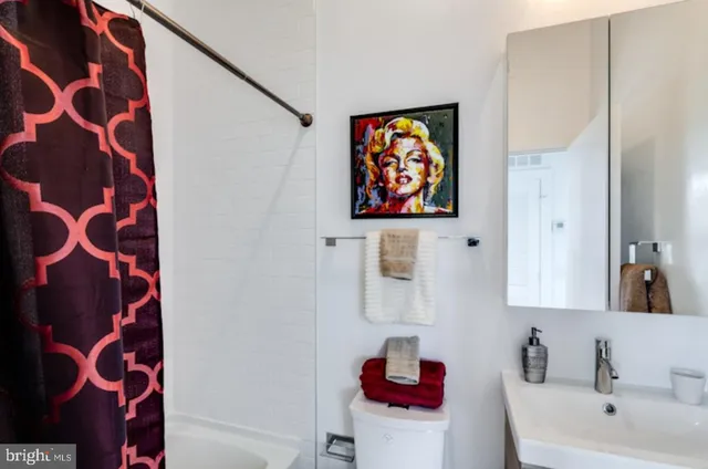 a living room with furniture a large window and a wooden floor