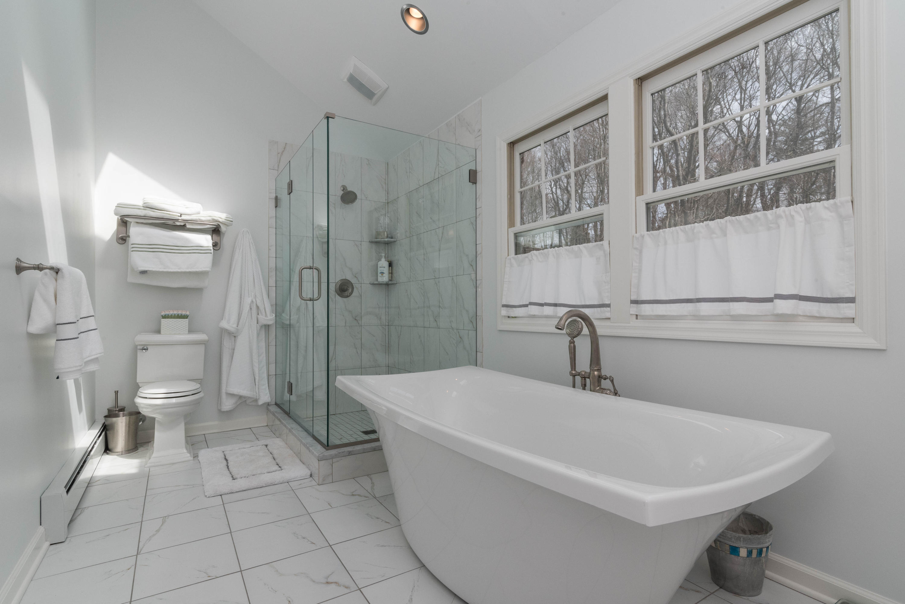 390 Middlesex Road Darien, CT 06820 - Photo 12 of 24 a white bath tub sitting next to a toilet