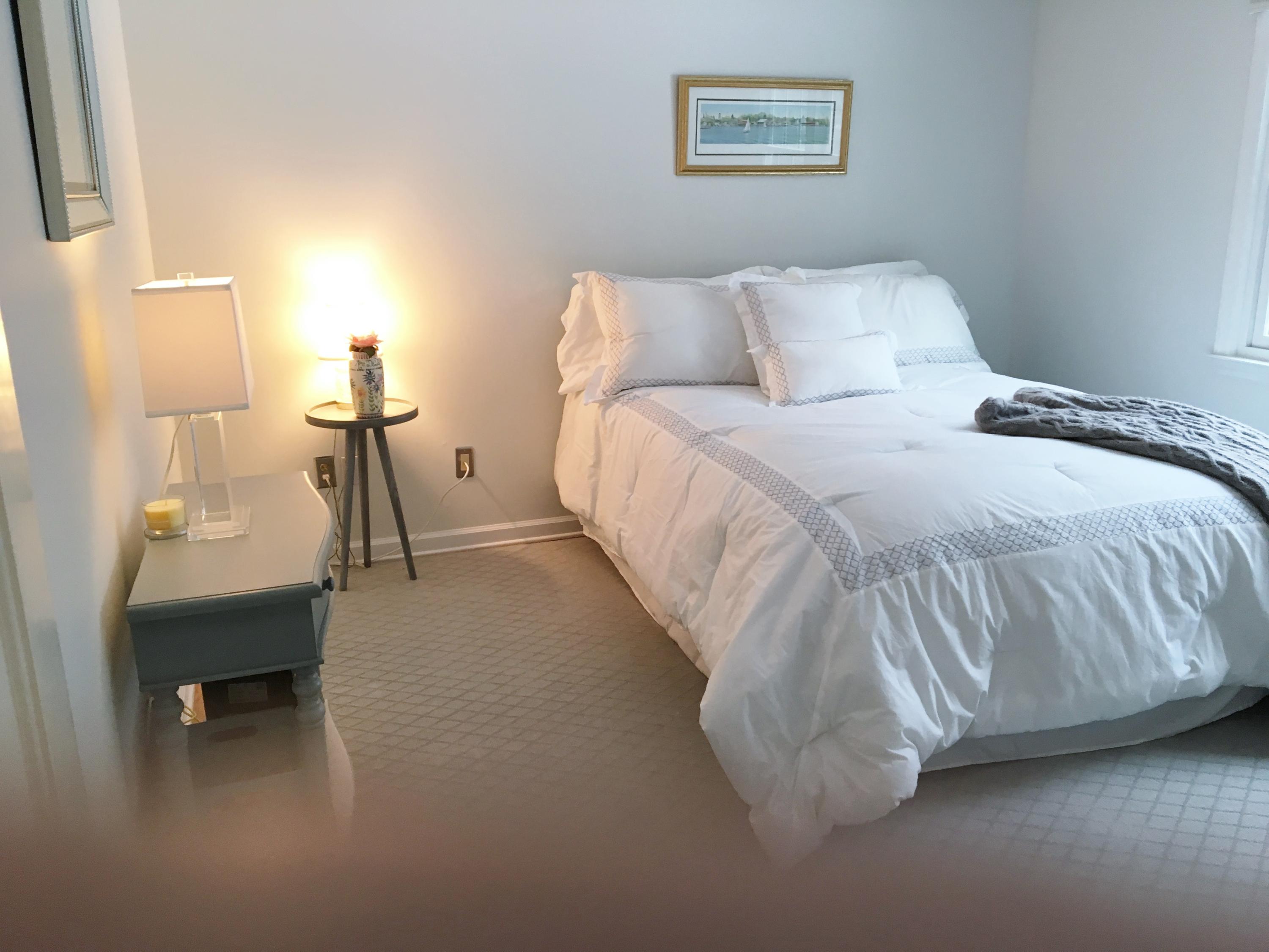 390 Middlesex Road Darien, CT 06820 - Photo 14 of 24 a bed room with a bed and a chair