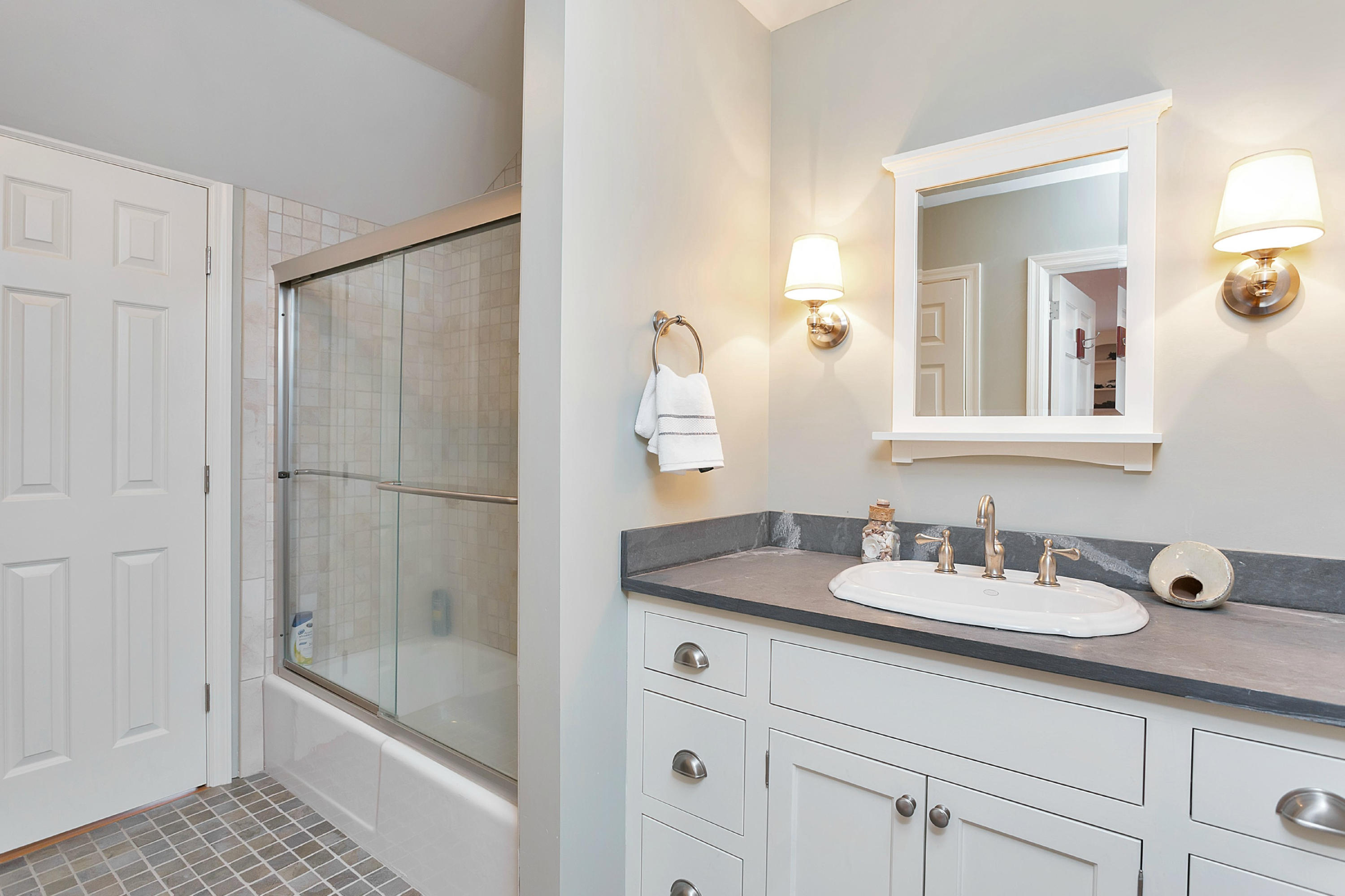 390 Middlesex Road Darien, CT 06820 - Photo 20 of 24 a bathroom with a granite countertop sink a mirror and a shower