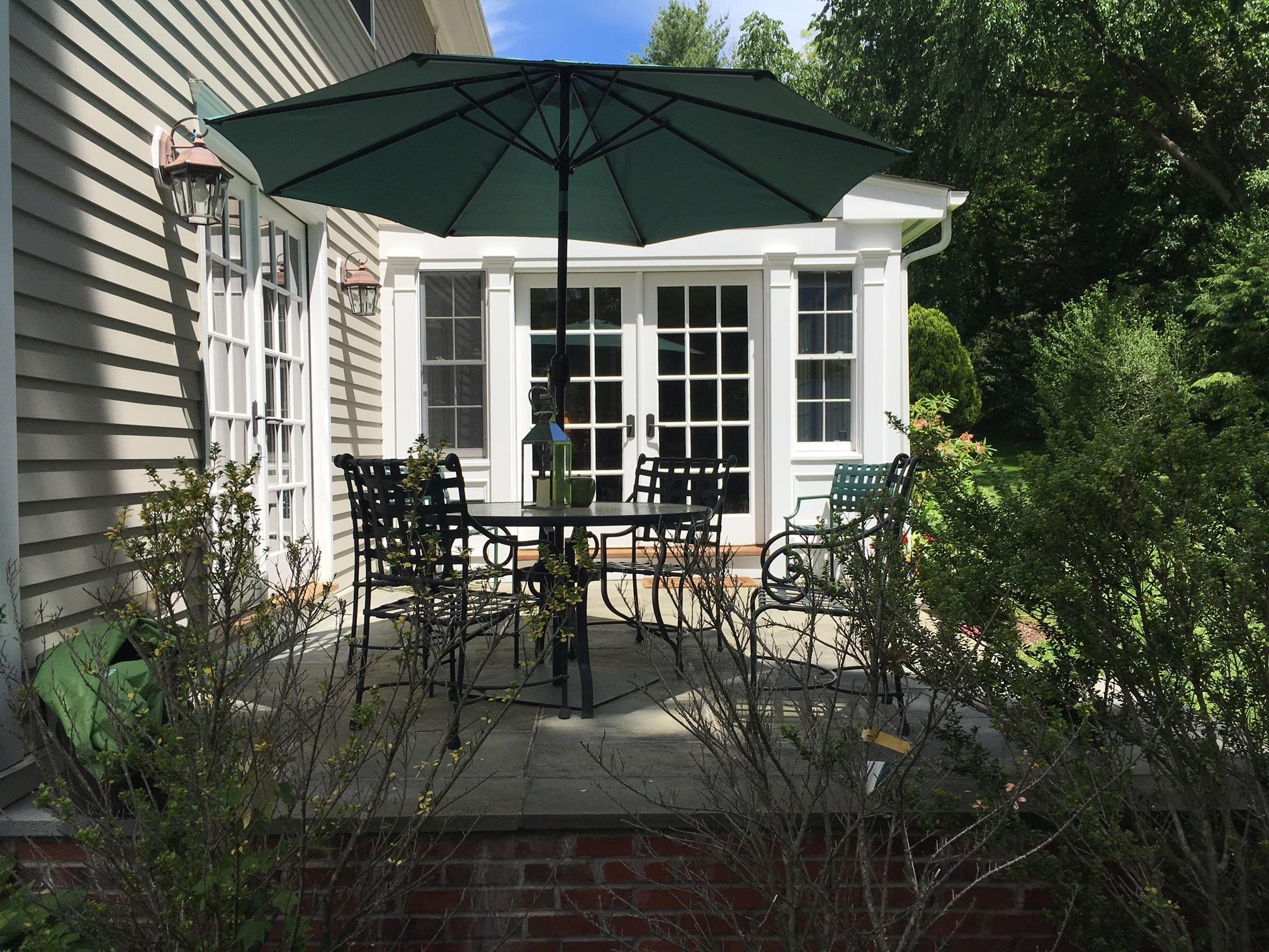 390 Middlesex Road Darien, CT 06820 - Photo 23 of 24 a table and chairs under an umbrella