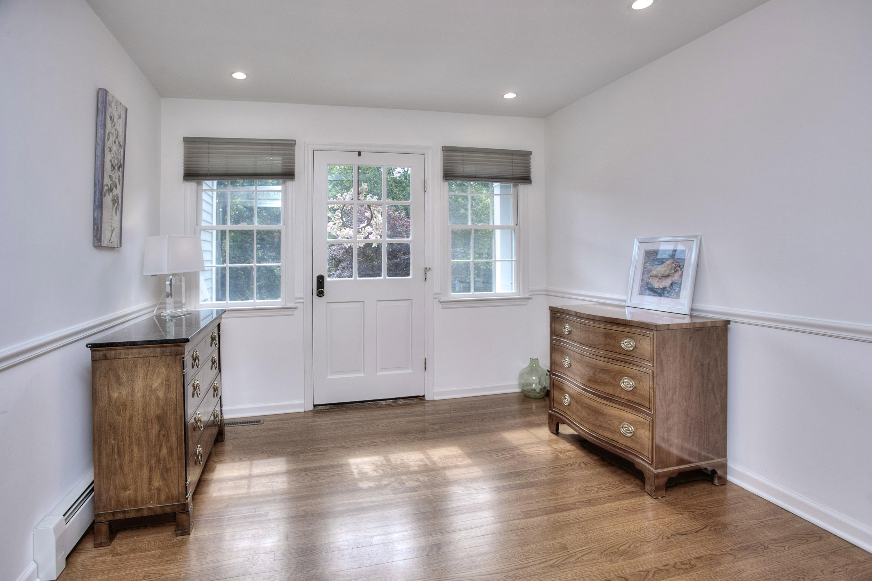 390 Middlesex Road Darien, CT 06820 - Photo 5 of 24 a view of an empty room with a window and wooden floor