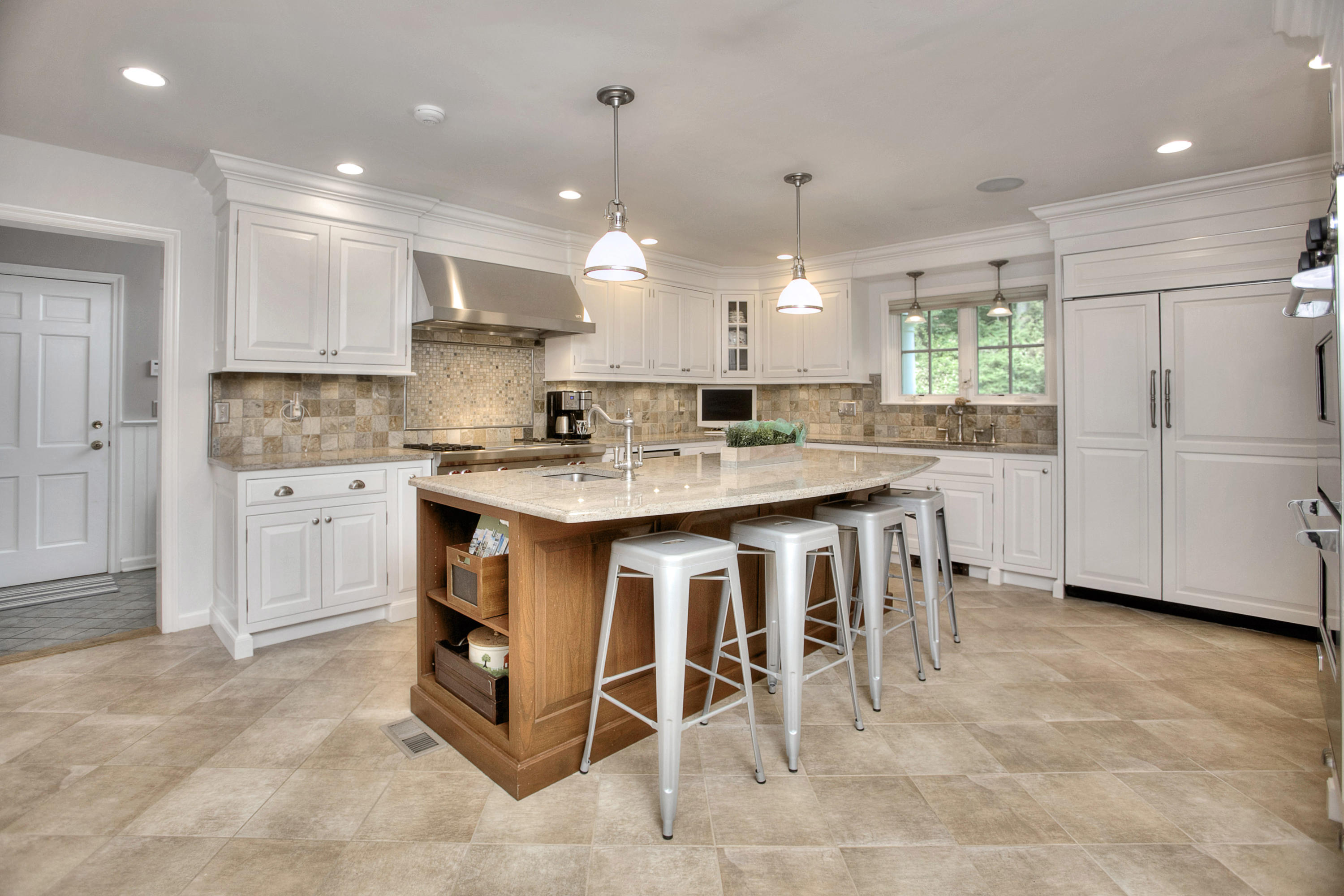 390 Middlesex Road Darien, CT 06820 - Photo 6 of 24 a kitchen with kitchen island cabinets and chairs