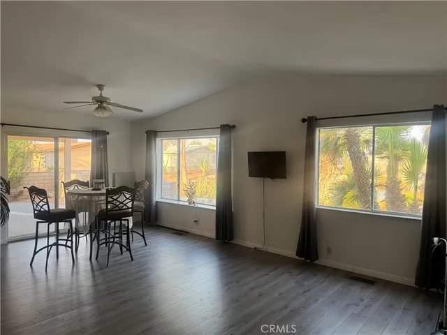 a view of a dining room with furniture and wooden floor