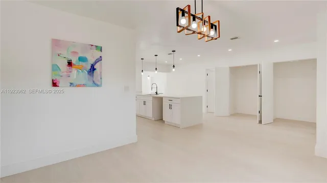 a view of an empty room with a cabinet