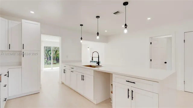 a kitchen with a sink a refrigerator and window