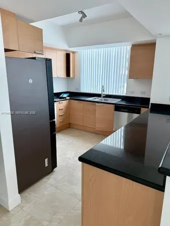 a kitchen with a refrigerator and microwave