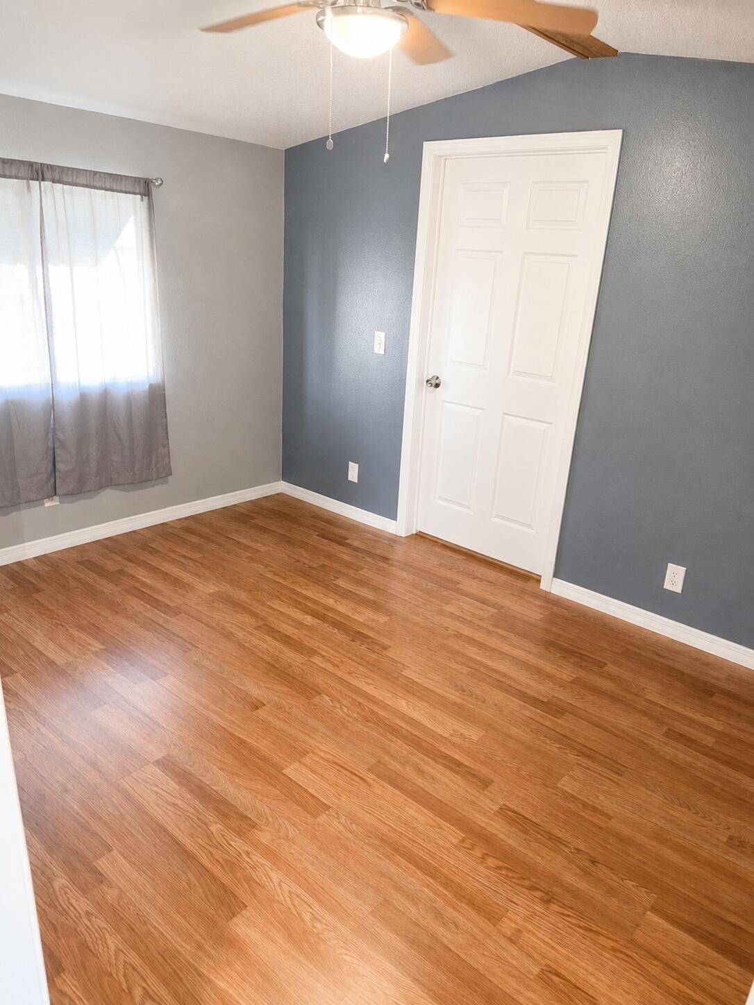 2547 Chatham Way Northeast Palm Bay, FL 32905 - Photo 9 of 24 an empty room with wooden floor and windows