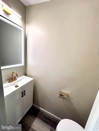 a bathroom with a sink mirror and toilet