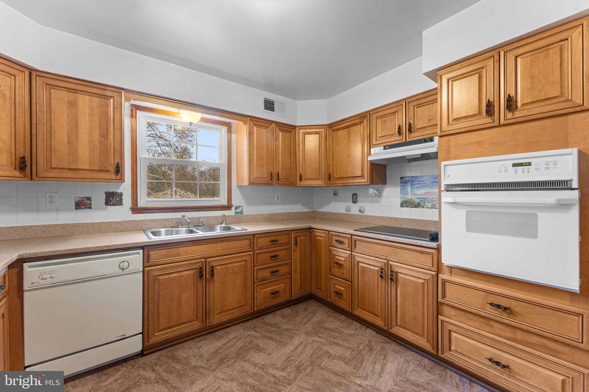 19227 Cardinal Heights Road Triangle, VA 22172 - Photo 18 of 64 a kitchen with sink cabinets and window
