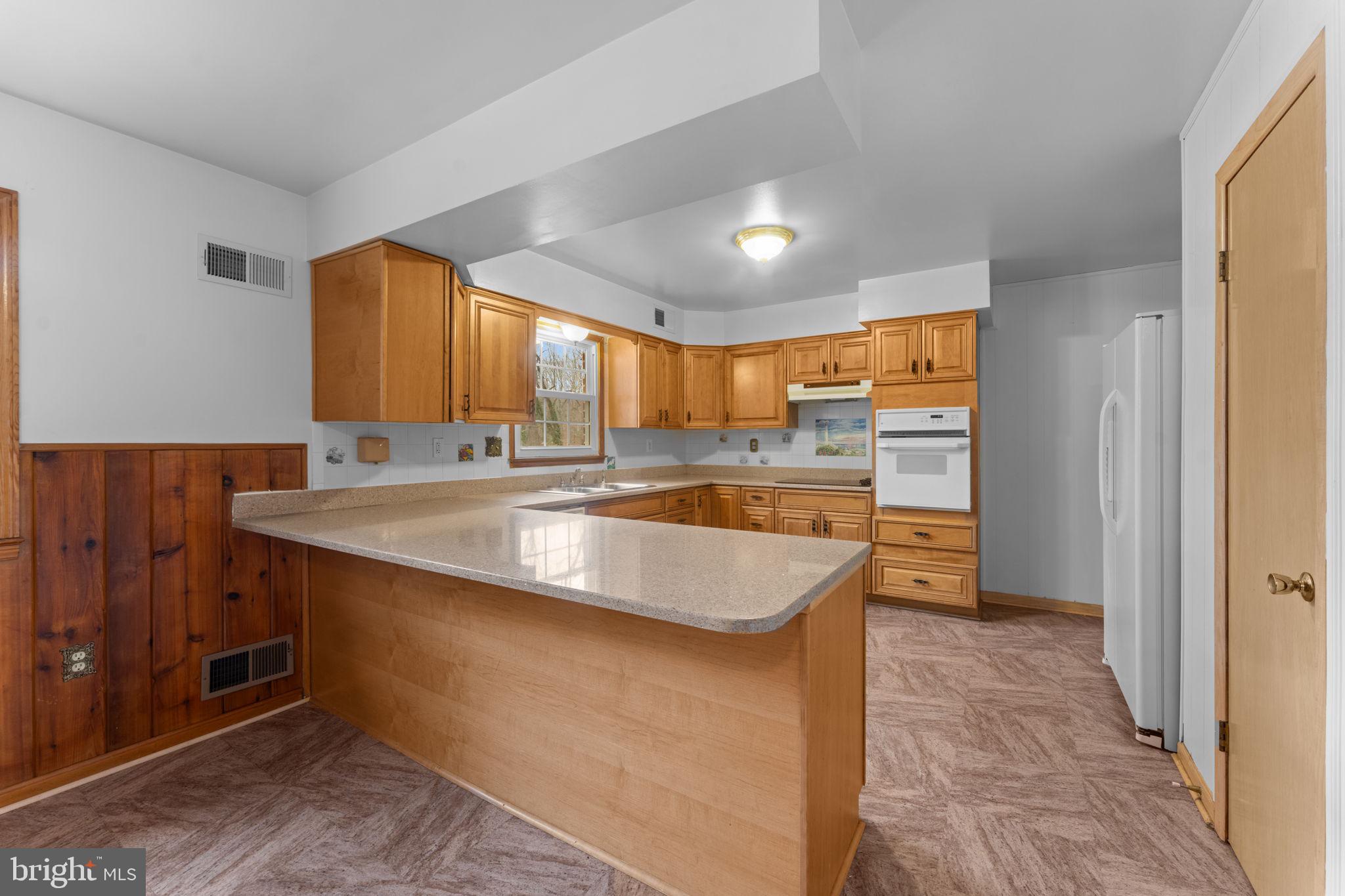 19227 Cardinal Heights Road Triangle, VA 22172 - Photo 19 of 64 a kitchen with stainless steel appliances granite countertop a sink a stove and a refrigerator