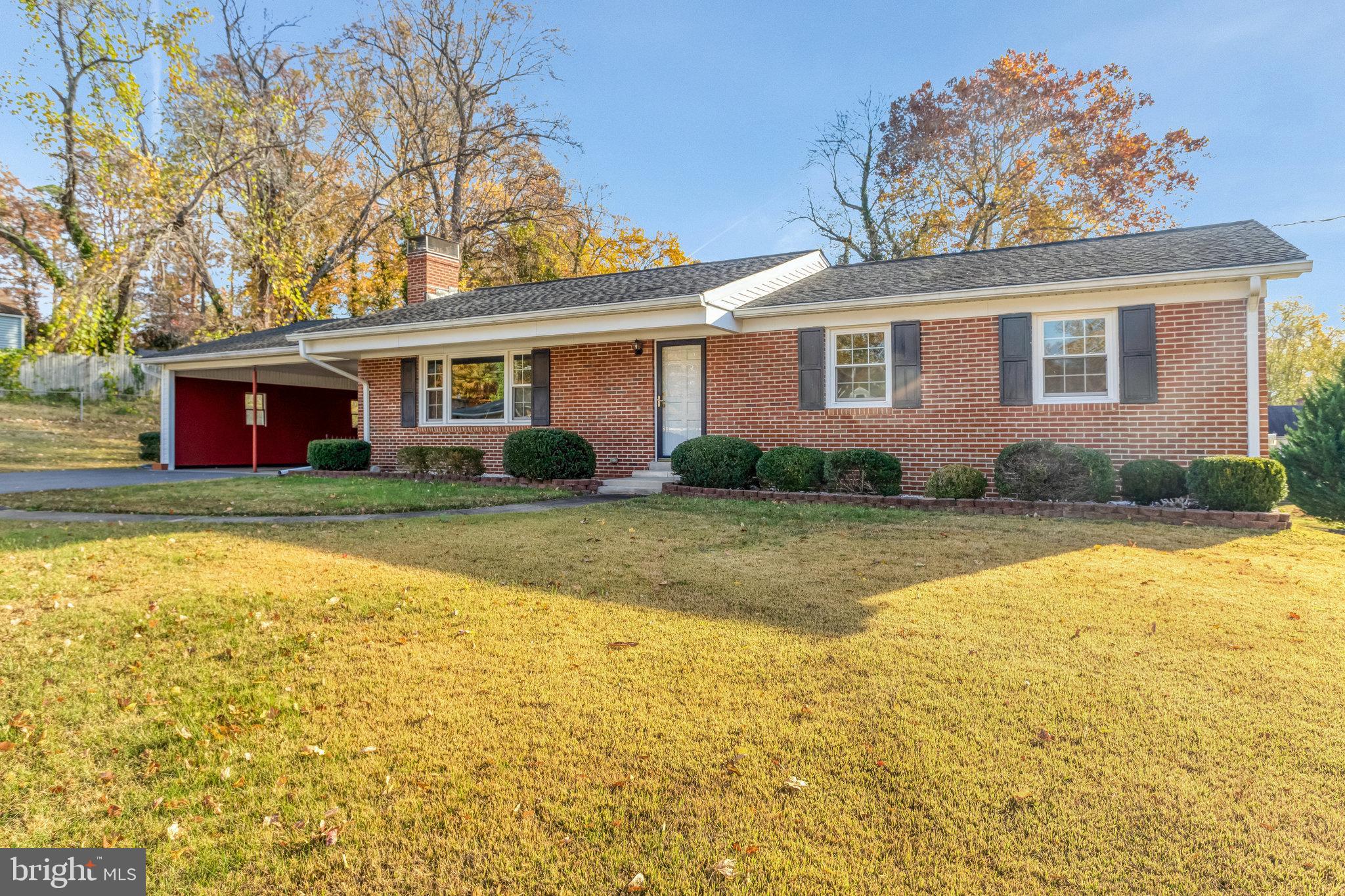 19227 Cardinal Heights Road Triangle, VA 22172 - Photo 2 of 64 a front view of house with yard and trees in the background
