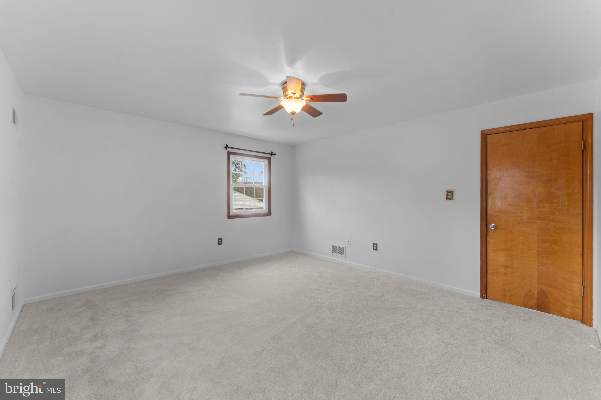 19227 Cardinal Heights Road Triangle, VA 22172 - Photo 22 of 64 an empty room with a window and a ceiling fan