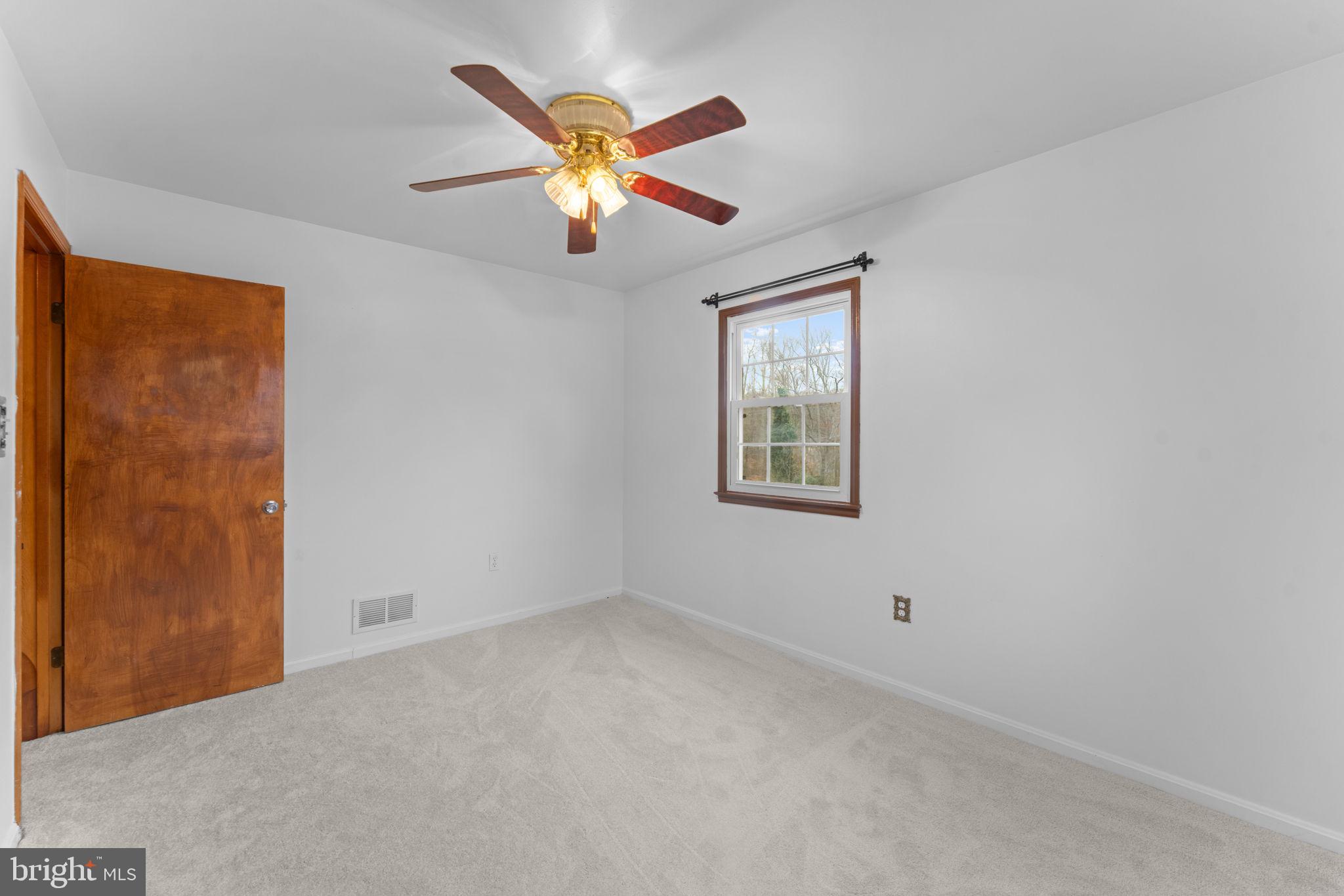 19227 Cardinal Heights Road Triangle, VA 22172 - Photo 28 of 64 an empty room with windows and fan