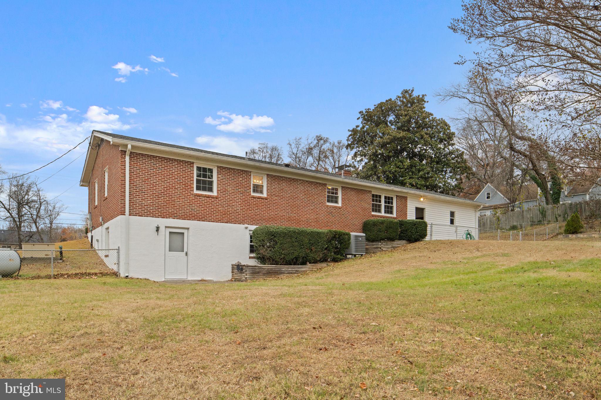 19227 Cardinal Heights Road Triangle, VA 22172 - Photo 52 of 64 a front view of house with yard and trees