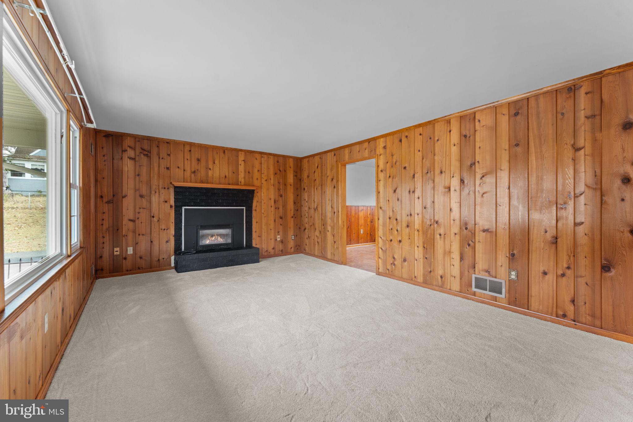 19227 Cardinal Heights Road Triangle, VA 22172 - Photo 9 of 64 a view of an empty room with a fireplace and a window