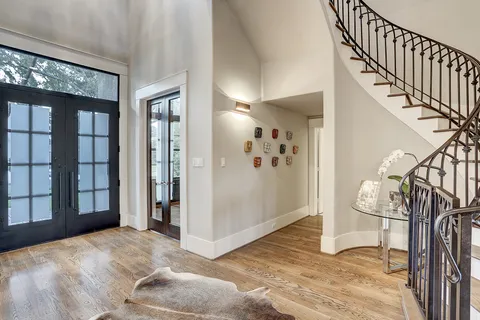 a view of entryway and hall with wooden floor