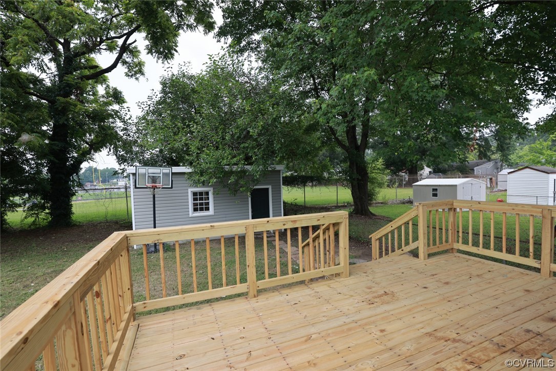 524 Chestnut Avenue Colonial Heights, VA 23834 - Photo 14 of 44 a view of a deck with a floor to ceiling window and wooden fence