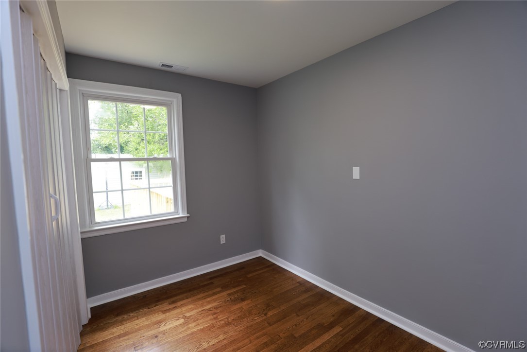 524 Chestnut Avenue Colonial Heights, VA 23834 - Photo 22 of 44 an empty room with wooden floor and windows