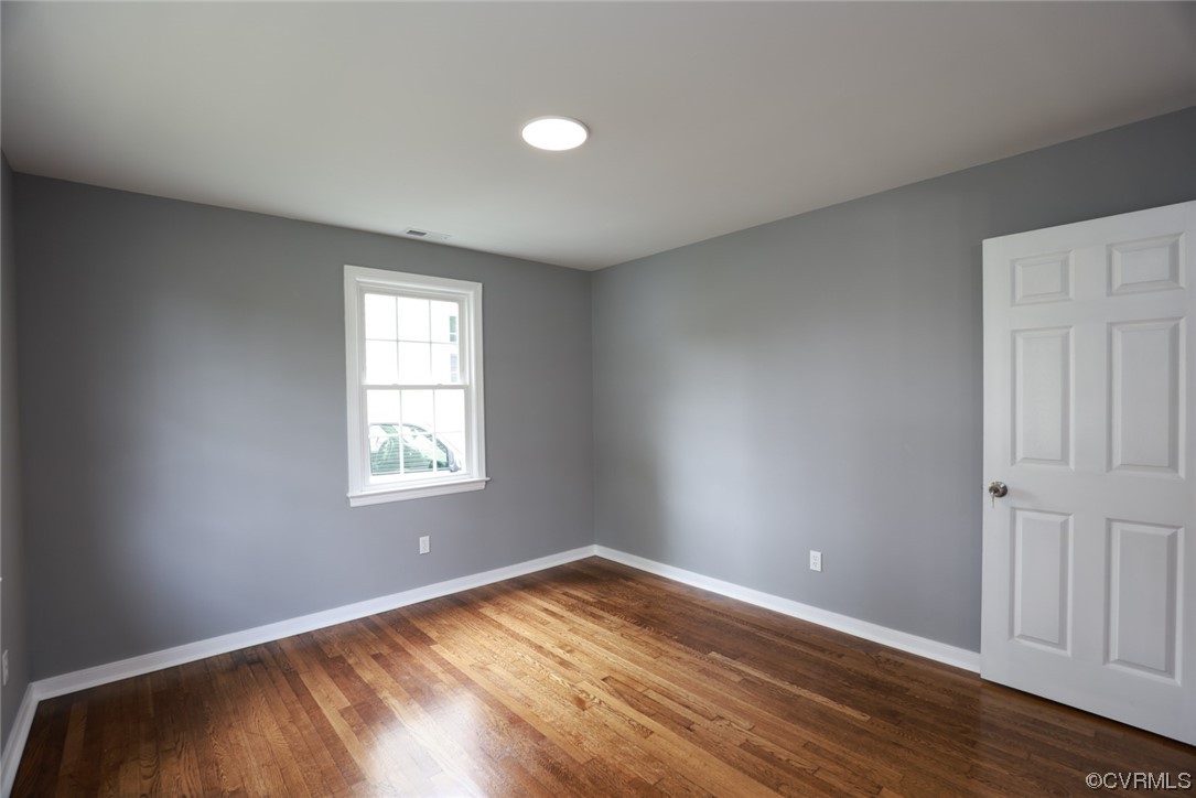 524 Chestnut Avenue Colonial Heights, VA 23834 - Photo 25 of 44 an empty room with wooden floor and windows