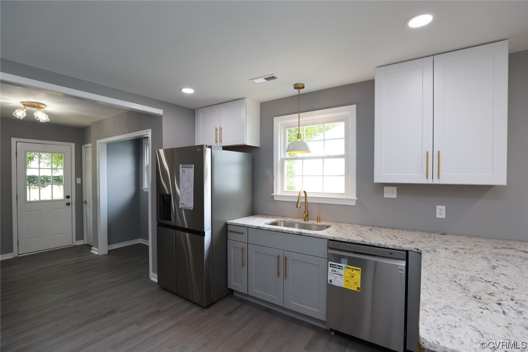 524 Chestnut Avenue Colonial Heights, VA 23834 - Photo 6 of 44 a kitchen with stainless steel appliances granite countertop a refrigerator a sink a stove a microwave and with wooden cabinets