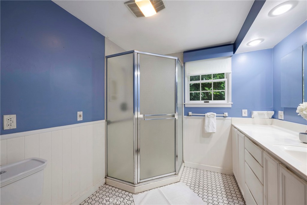 1146 North Puente Street Brea, CA 92821 - Photo 8 of 36 a bathroom with a sink a mirror and a shower