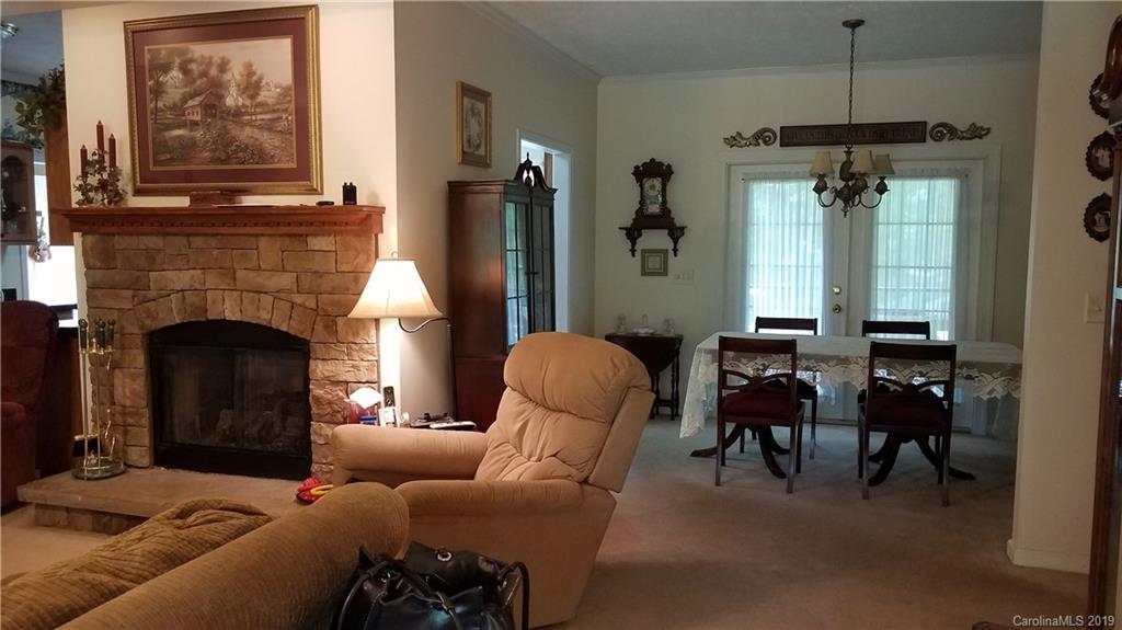 732 Lookout Tower Road Blacksburg, SC 29702 - Photo 10 of 31 a living room with furniture a fireplace and a chandelier